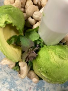 Greens, avocados and cashews in a food processor