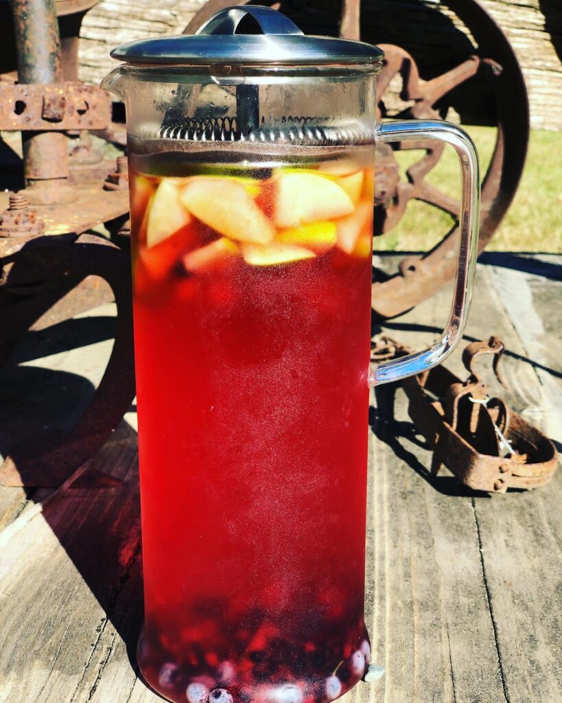 Oregeon grape berry iced tea with blackberries and apples, steeping in the summer sun as a solar infustion